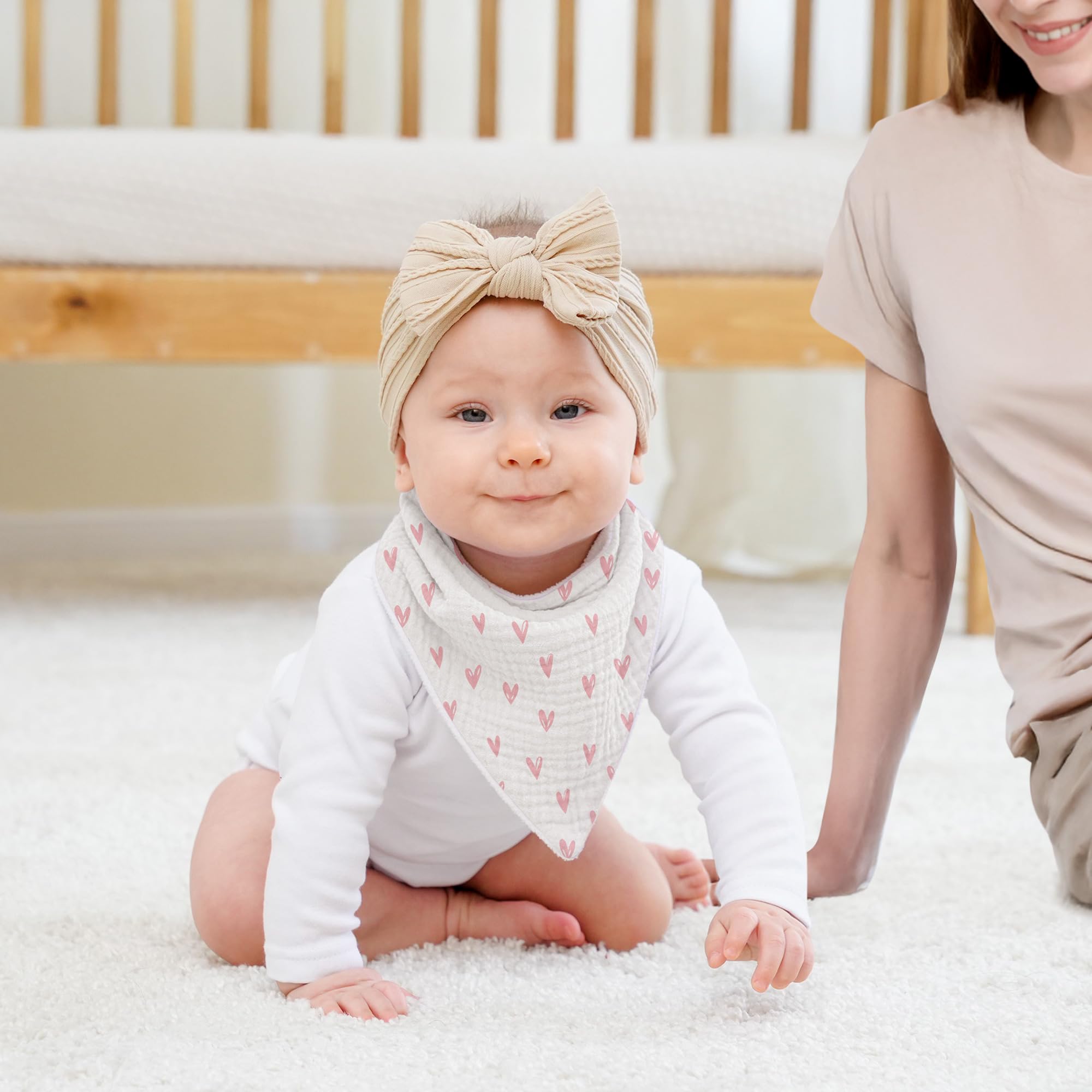 Susurration muslin baby bib soft absorbency highlighted in flatlay for daily drool relief.