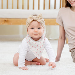 Susurration muslin baby bib soft absorbency highlighted in flatlay for daily drool relief.