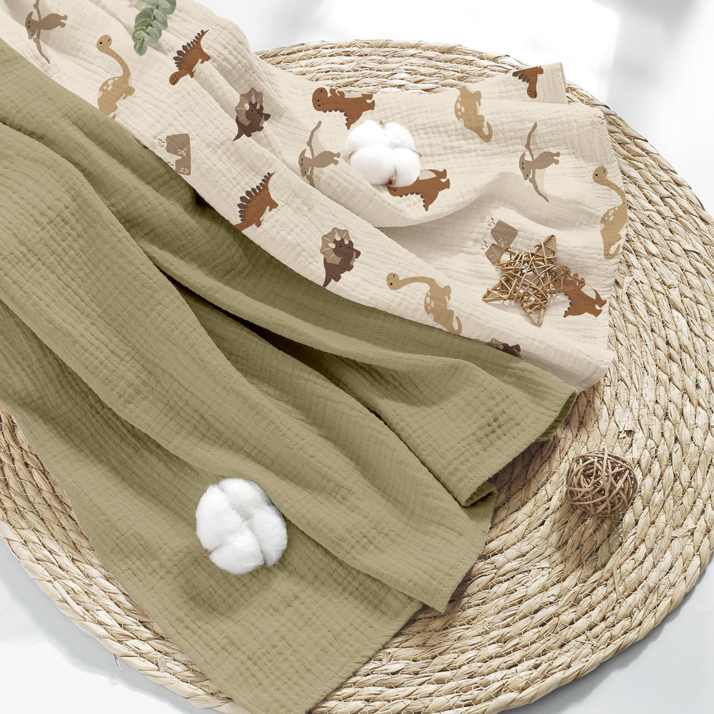 Folded Susurration muslin blanket highlighting unisex design for everyday use.