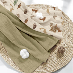 Folded Susurration muslin blanket highlighting unisex design for everyday use.