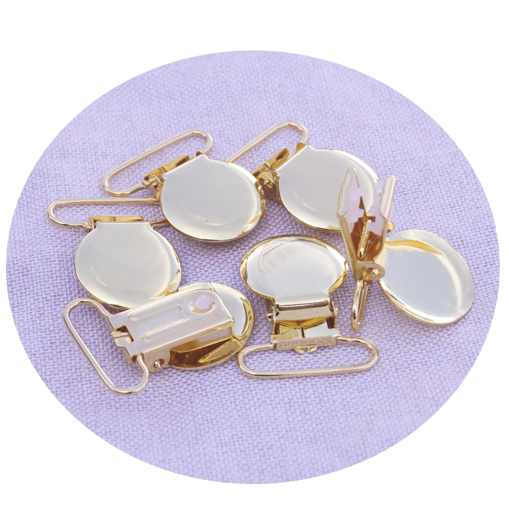 Sutoyuen gold pacifier clip ideal for ribbon-based holders.