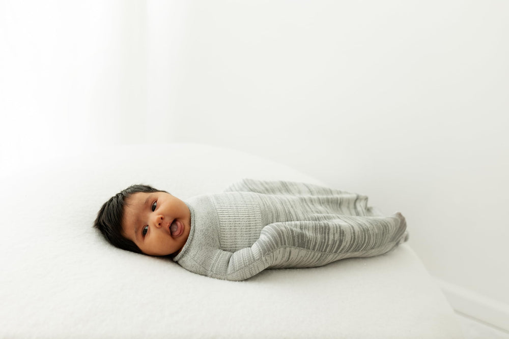 Swaddelini grey swaddle sleep sack fabric close-up showing breathable material.