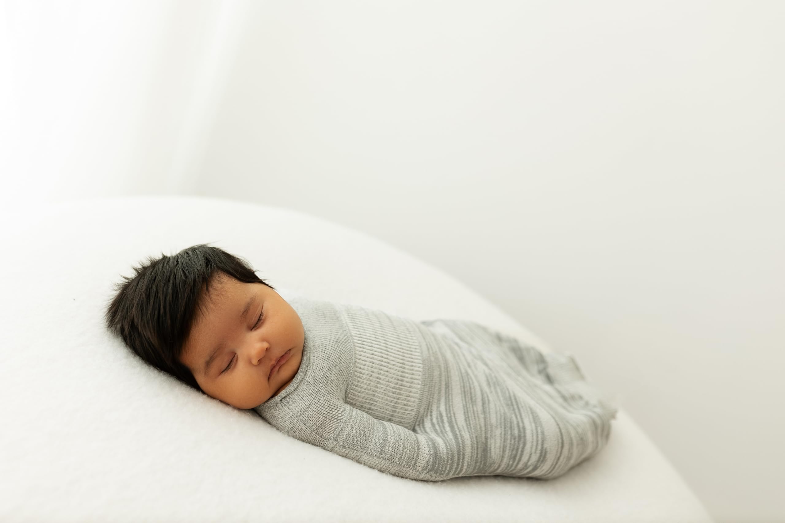 Swaddelini grey swaddle sleep sack zipper detail for easy night changes.