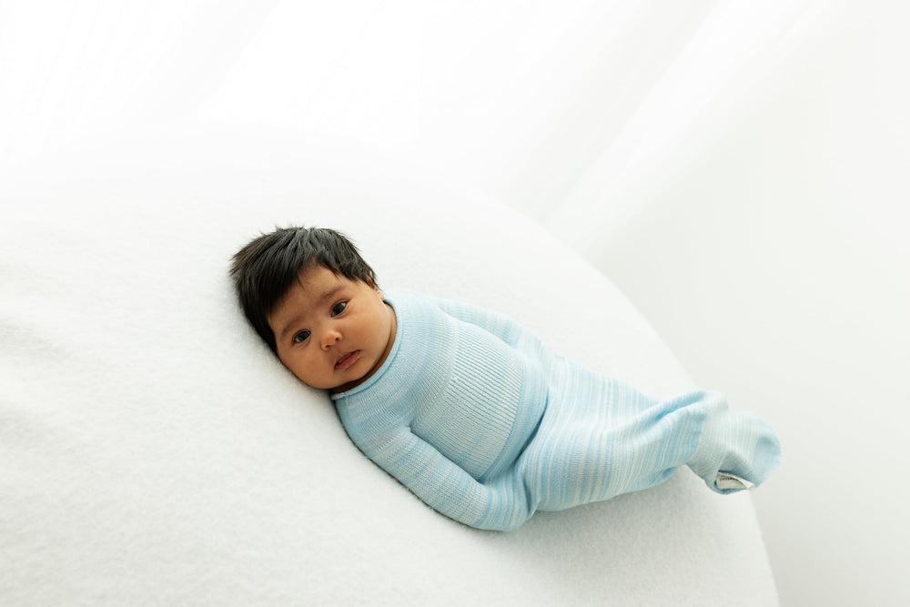 Swaddelini blue sleep sack in use promotes secure, comfortable sleep.
