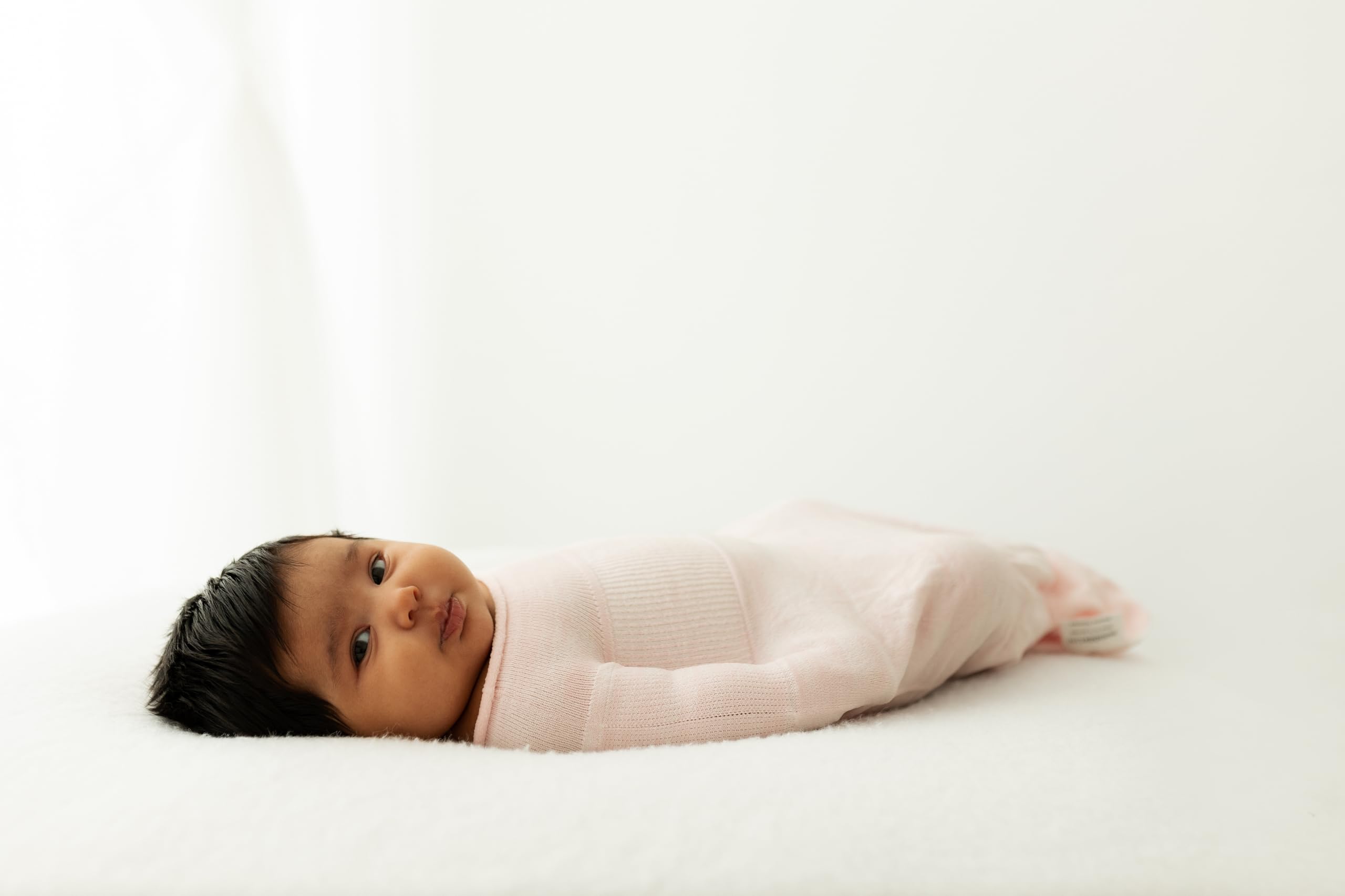 Swaddelini Swaddle Sleep Sack Pink in use demonstrates snug comfort for peaceful sleep.