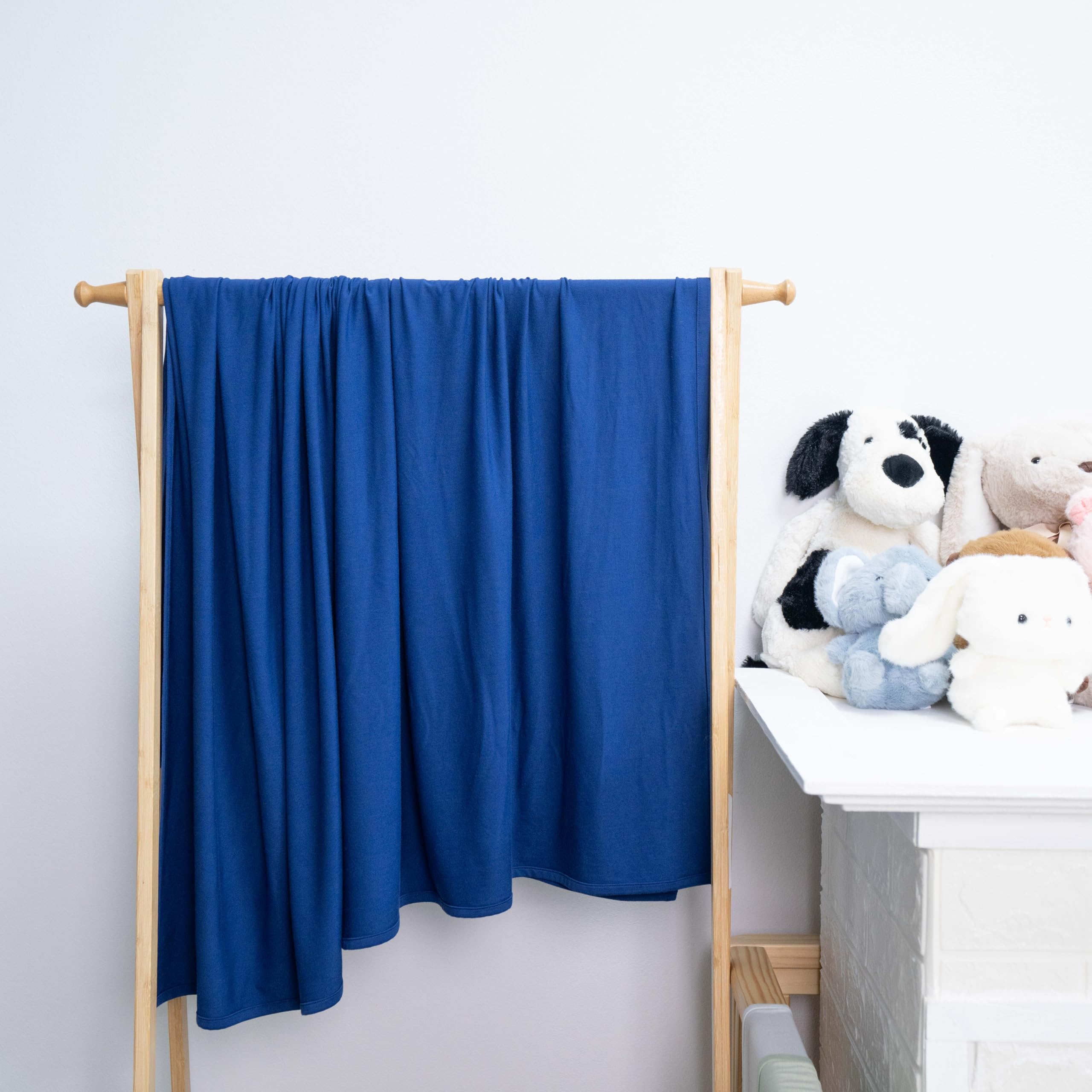 SWaddle AN blue depths blanket serving as receiving blanket for newborn cuddles