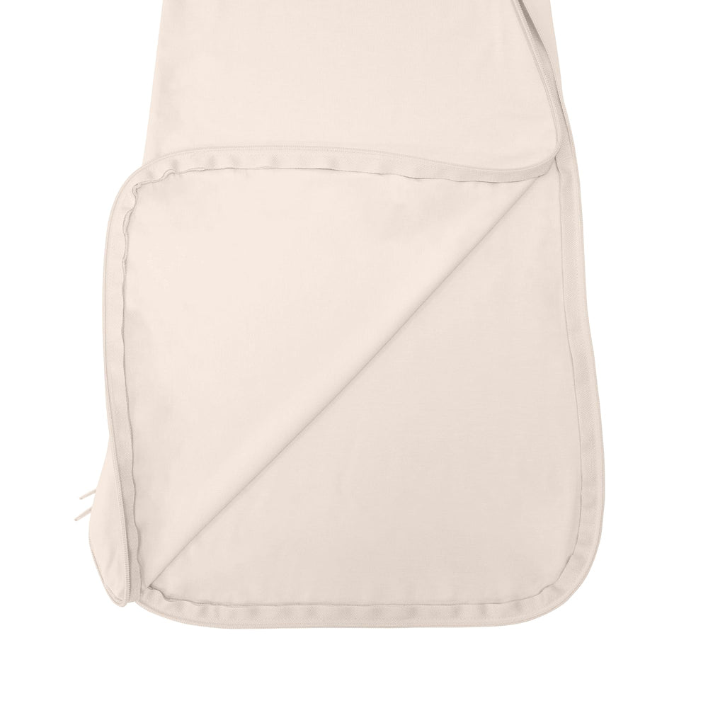 SWaddle AN unisex sleep bag featuring top and bottom zipper for quick changes.