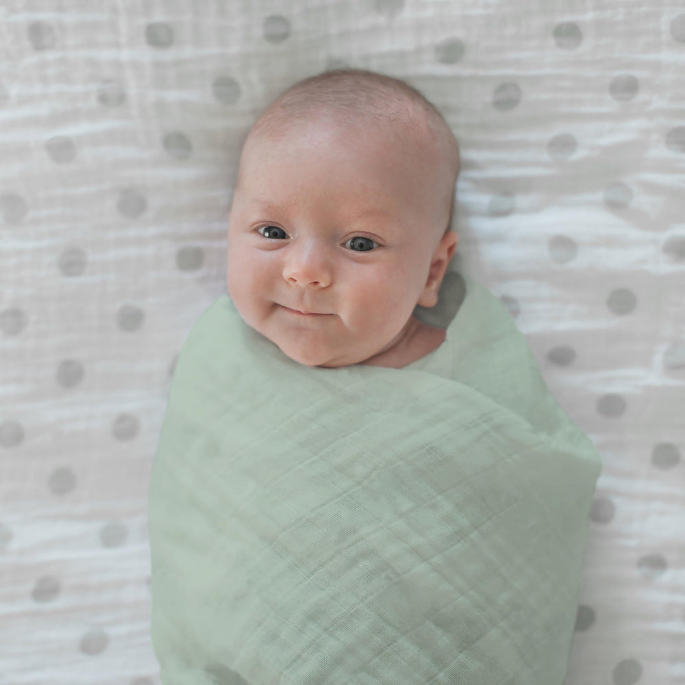 Baby wrapped in Jadeite swaddle during a nap for comfort and security.