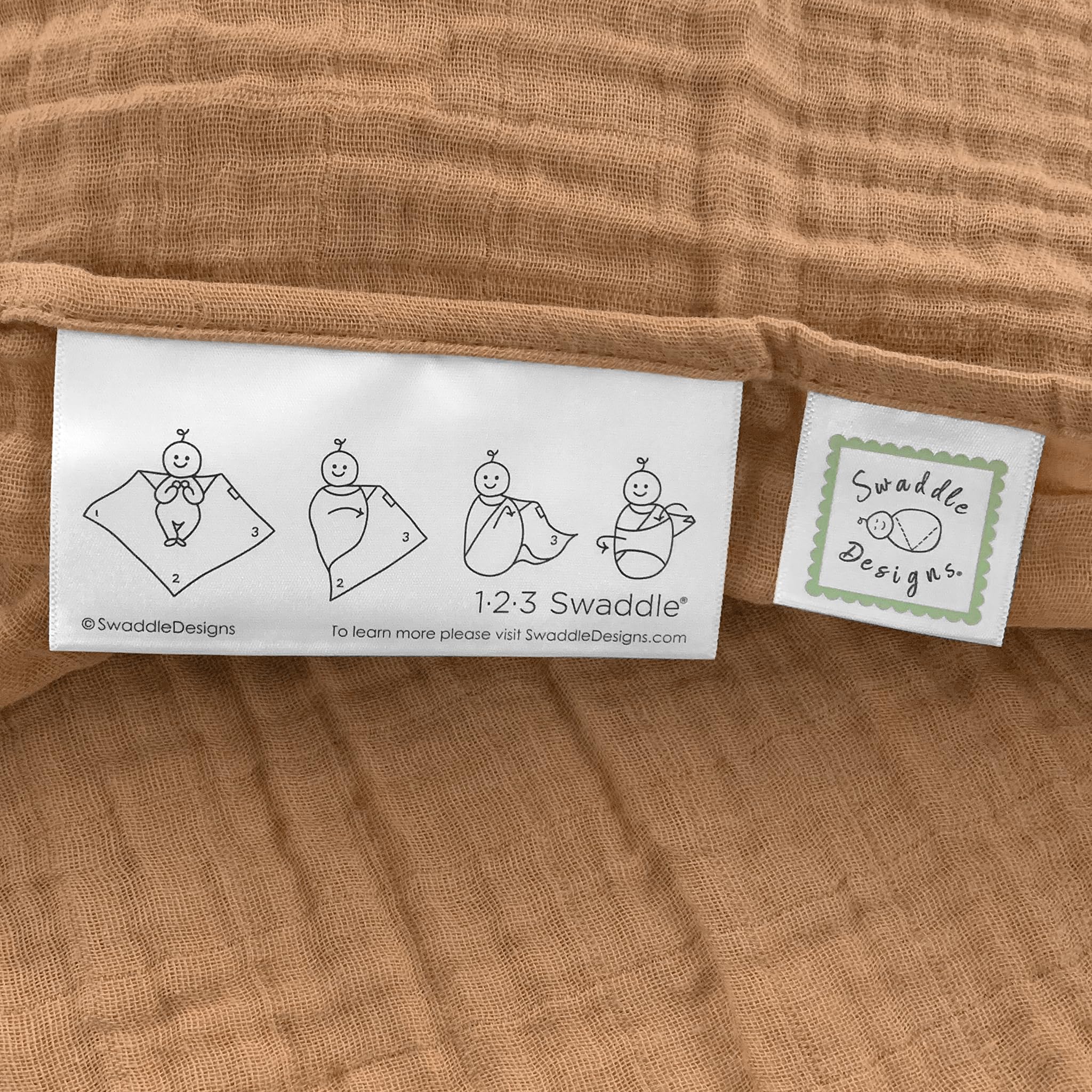 SwaddleDesigns Butterum blanket edge with 123 Swaddle label aids easy swaddling.