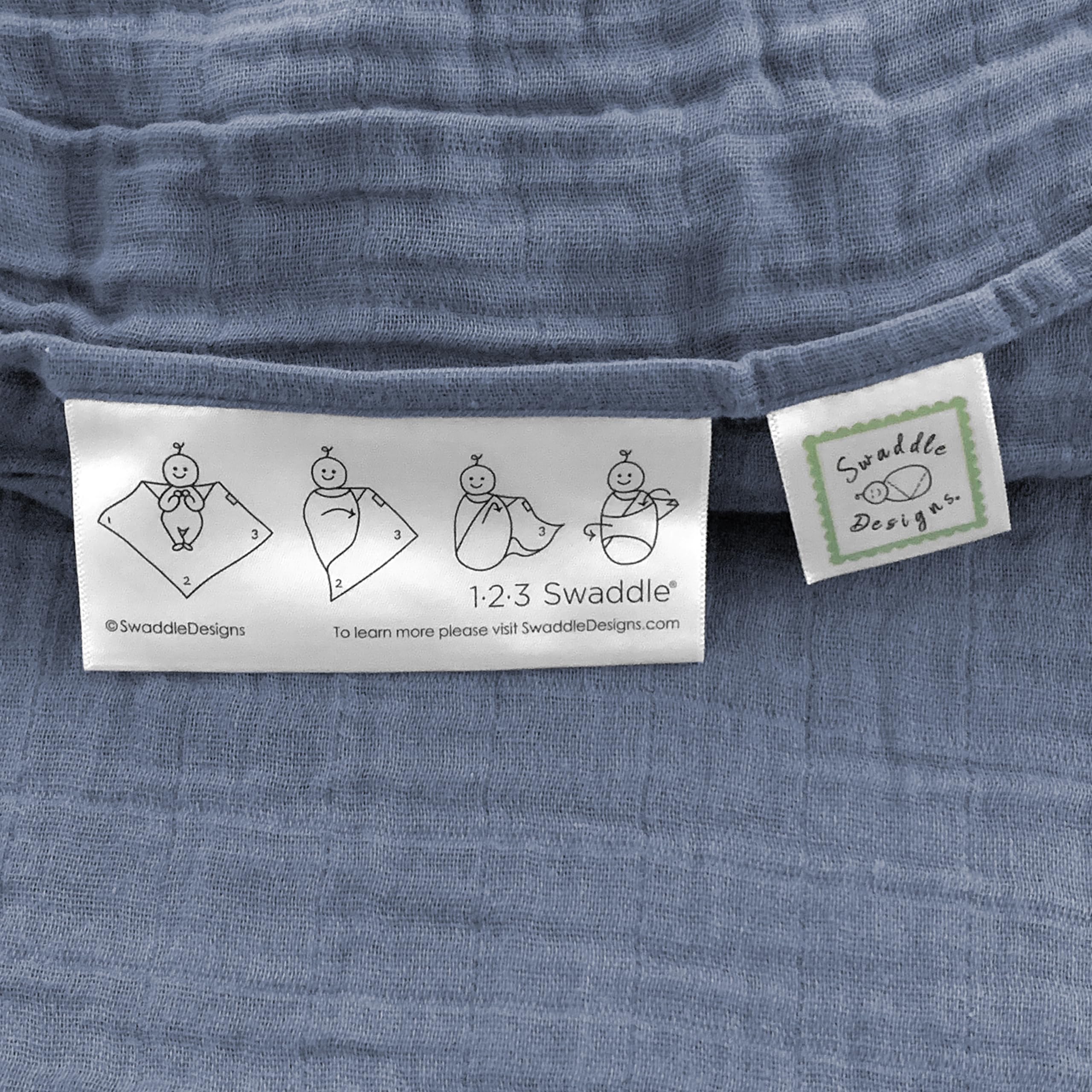SwaddleDesigns denim muslin swaddle blanket with easy swaddle label.