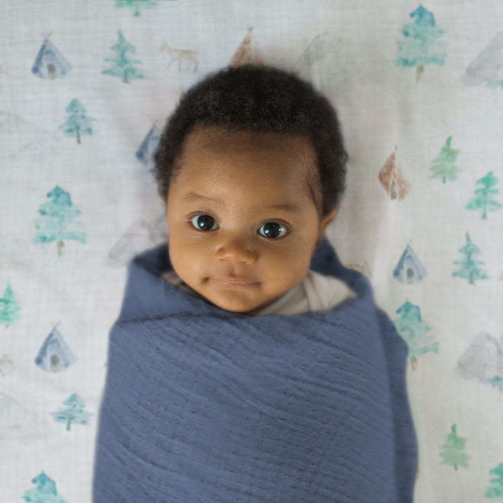 SwaddleDesigns denim muslin swaddle blanket ready for machine washing.