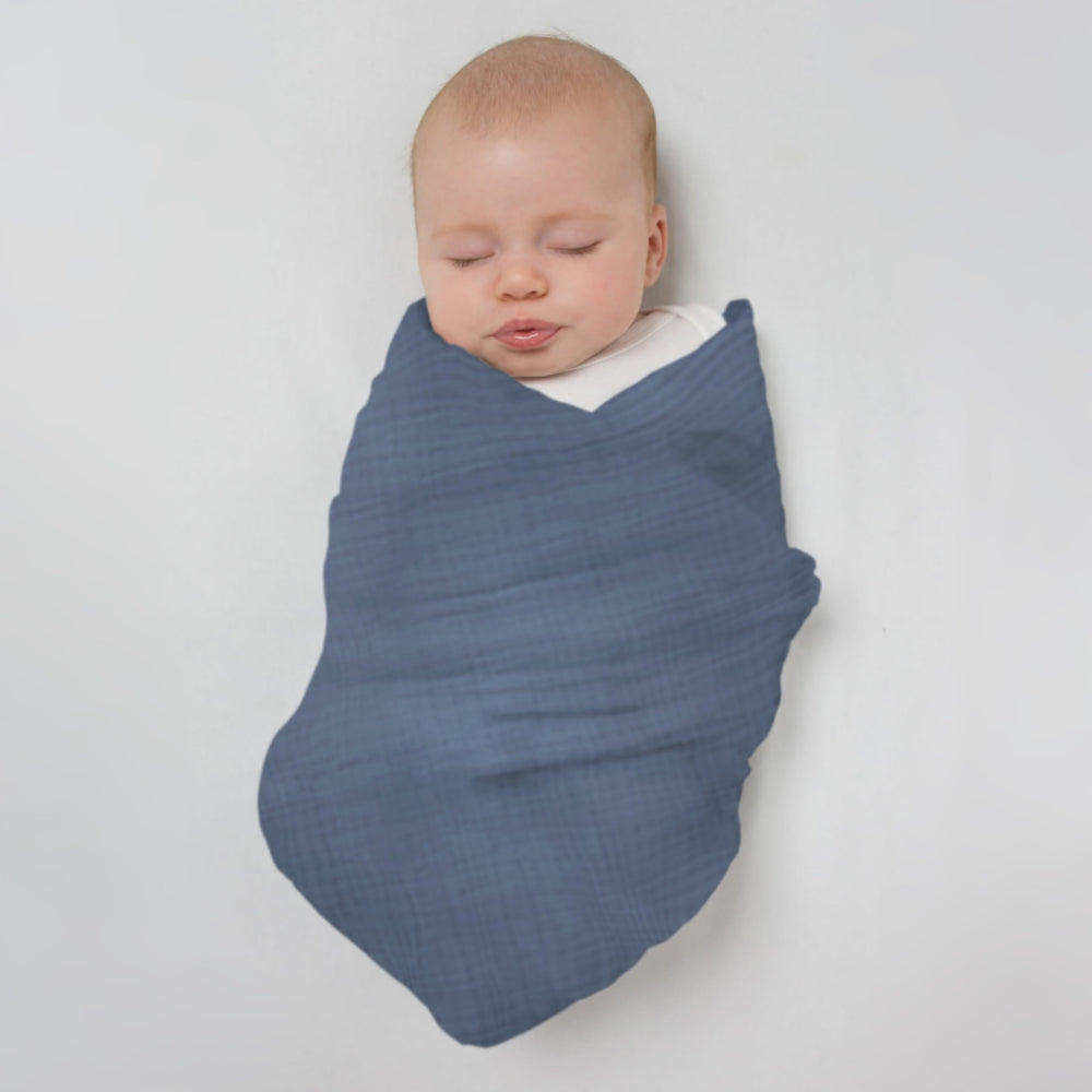 SwaddleDesigns denim muslin swaddle blanket on display for nursery styling.