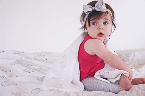 Tummy-time setup with SwaddleDesigns muslin blanket on the floor