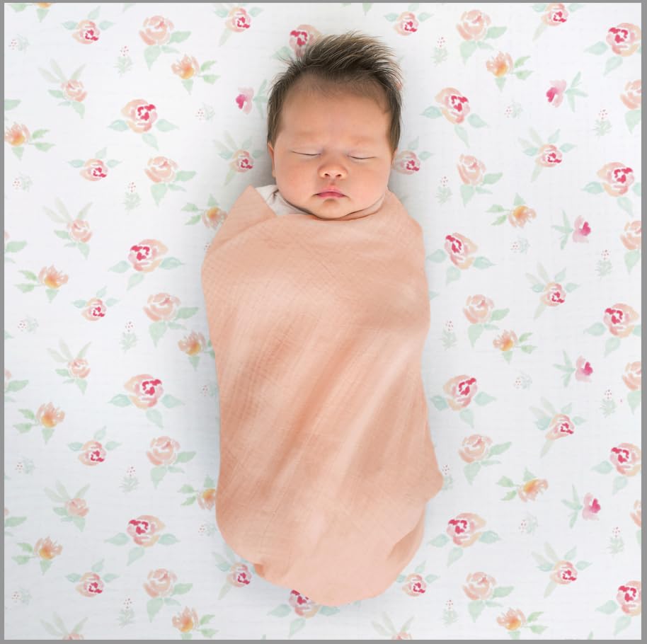 Baby swaddled with SwaddleDesigns Spring Garden blanket for calm rest.