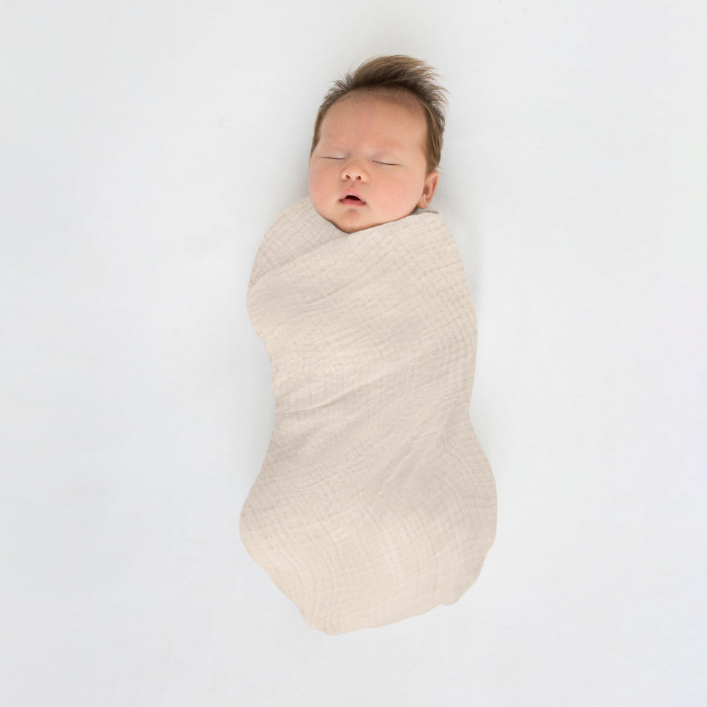 Tummy-time with SwaddleDesigns Spring Garden blanket on soft surface.