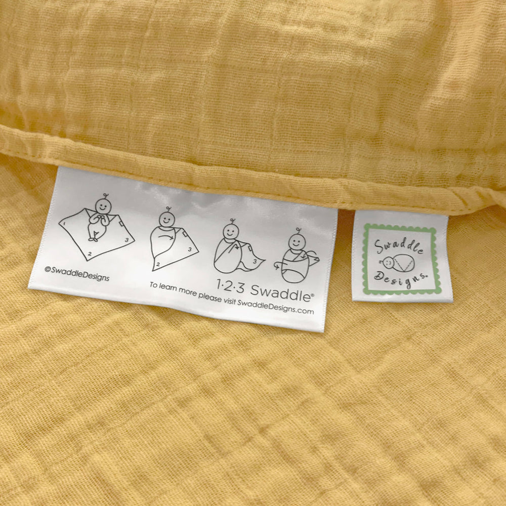 SwaddleDesigns sunshield-stroller image, lightweight muslin shades baby on outings.