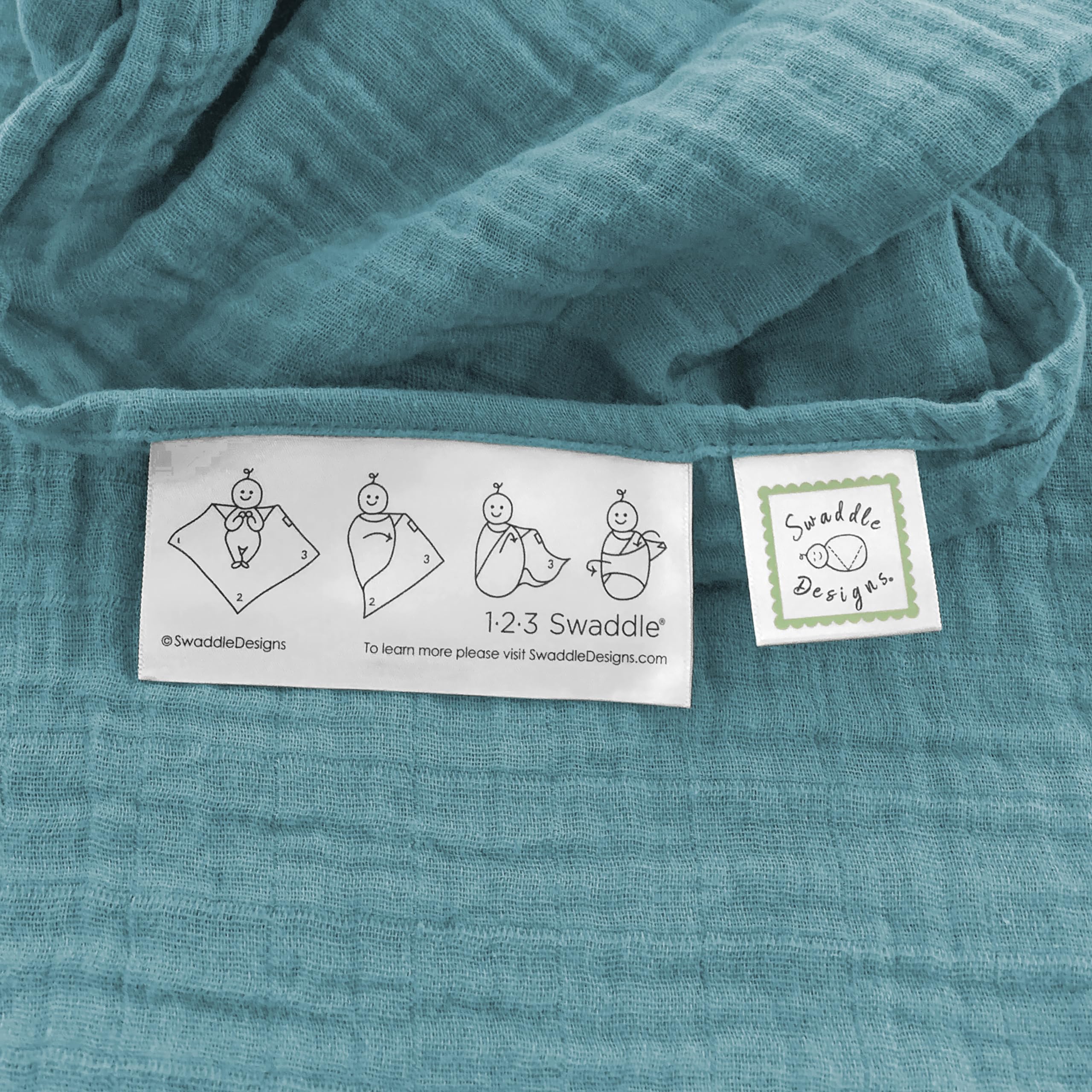 SwaddleDesigns teal cotton muslin blanket draped as sunshield on a stroller