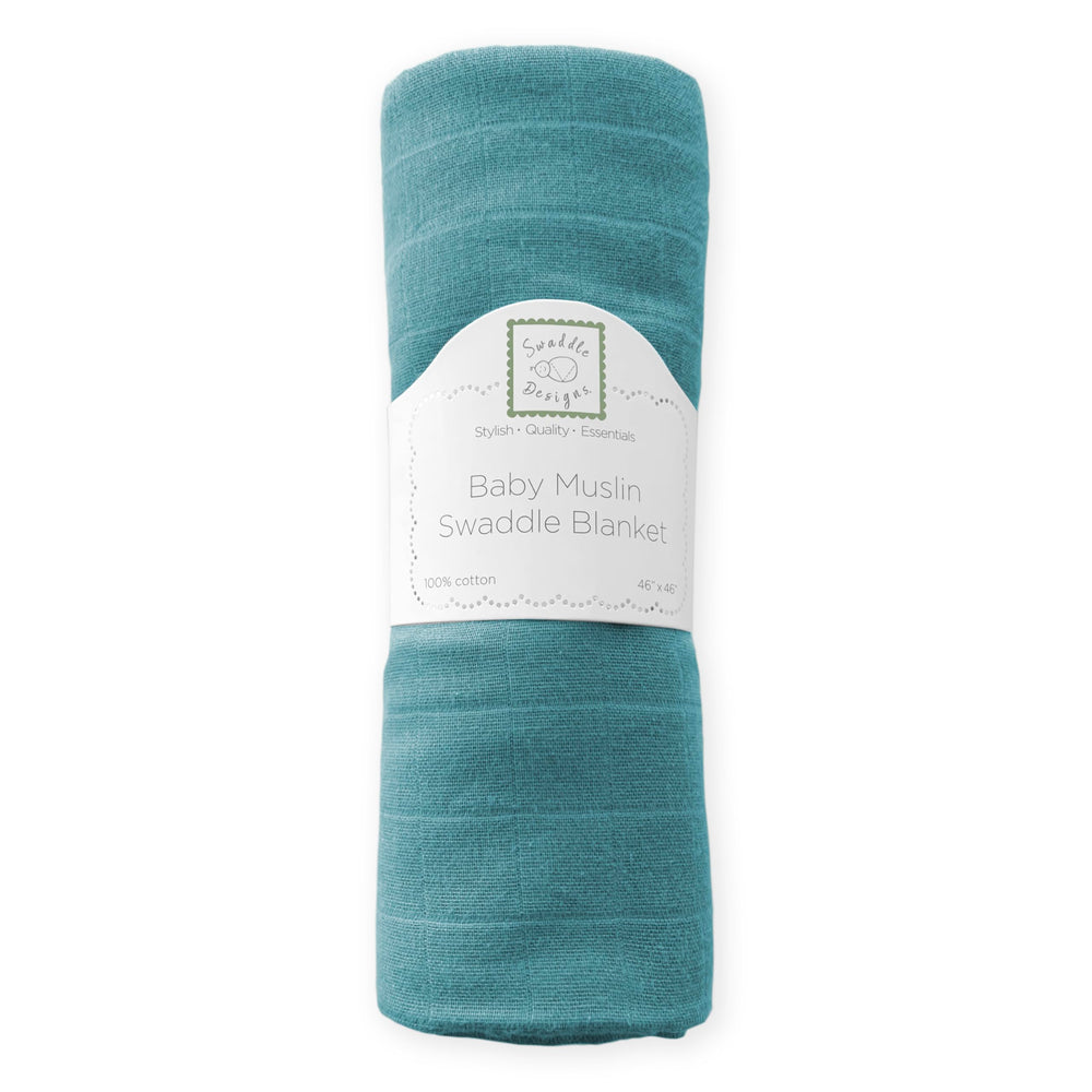 SwaddleDesigns teal muslin blanket swaddling a baby to highlight easy wrap steps