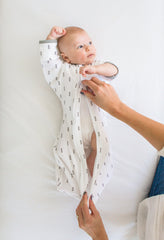 SwaddleDesigns arms up swaddle with closed mitten cuffs helps contain tiny hands.