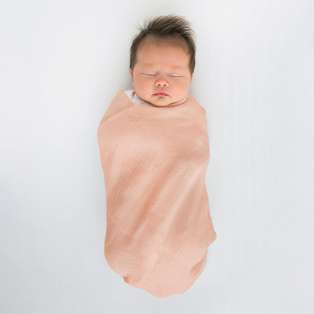 SwaddleDesigns versatile blanket used as sunshield and nursing cover.