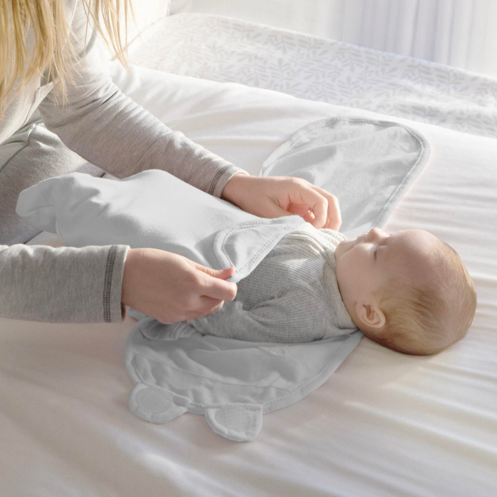 SwaddleMe Original arms-in design comforts babies seeking snug containment.