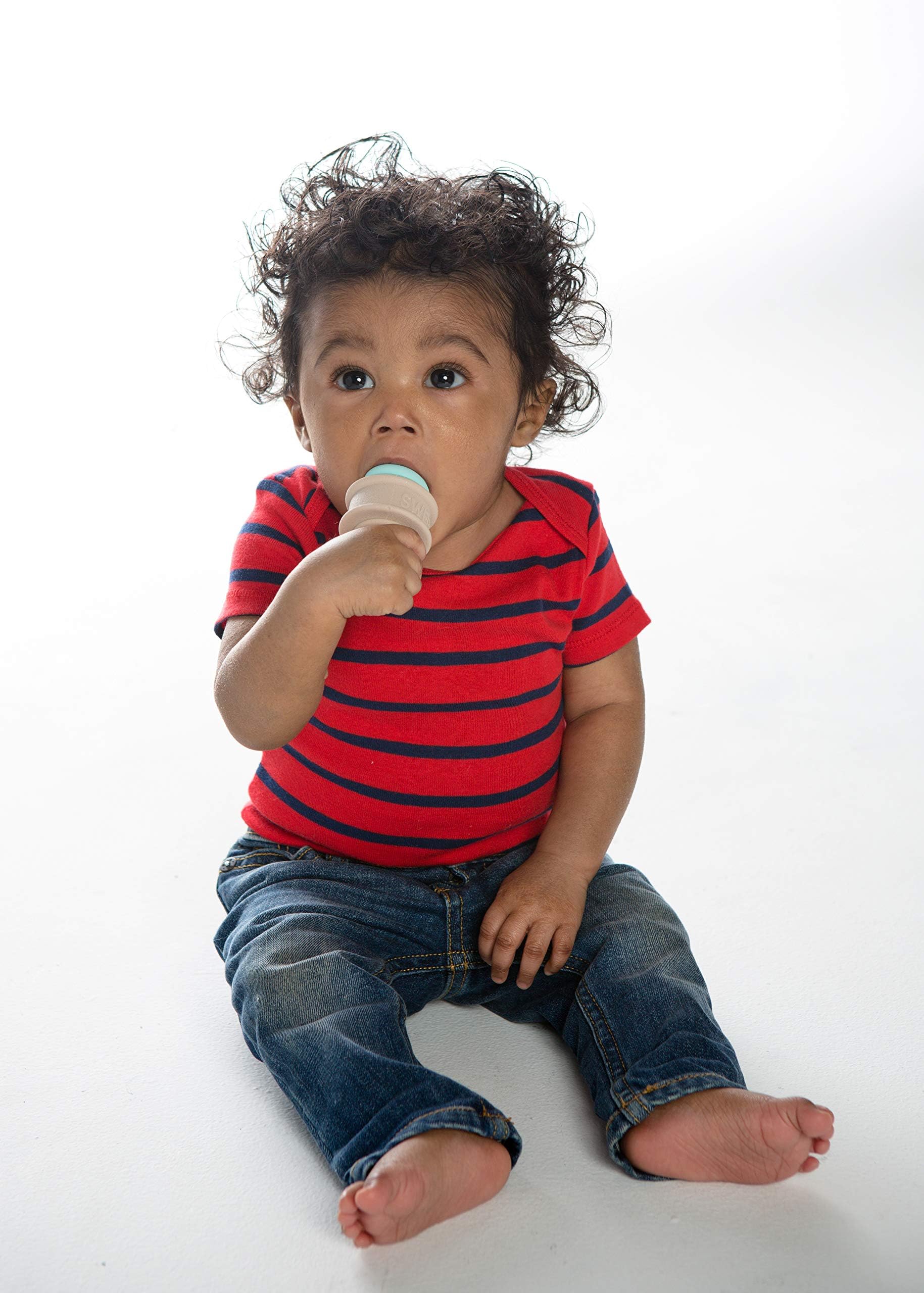 Baby holding SweeTooth teether, showcasing ergonomic grip and ease of use.