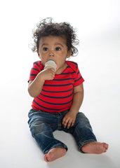 Baby holding SweeTooth teether, showcasing ergonomic grip and ease of use.
