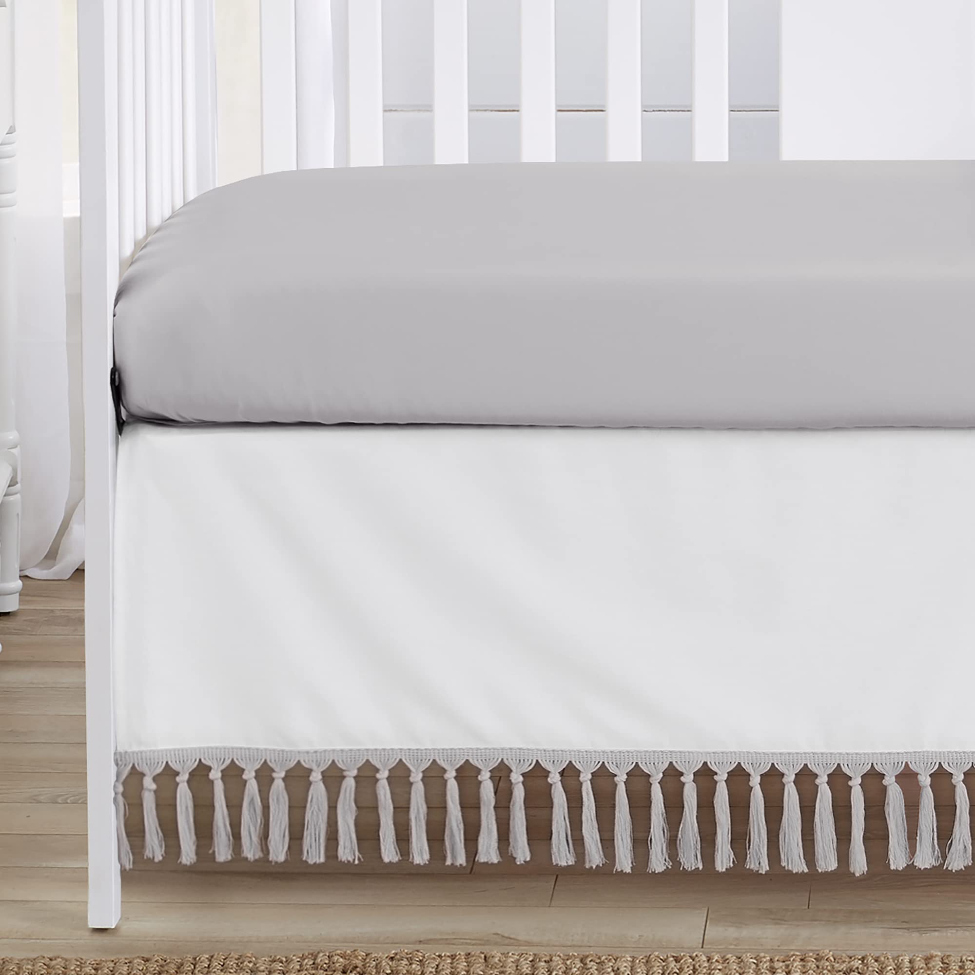 Sweet Jojo Designs crib skirt in gray-white adds a tidy nursery finish.