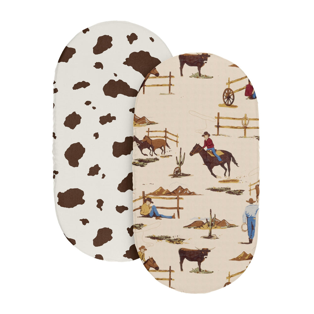 Sweet Jojo Designs cow print bassinet sheet on bed demonstrating snug fit and elastic edges