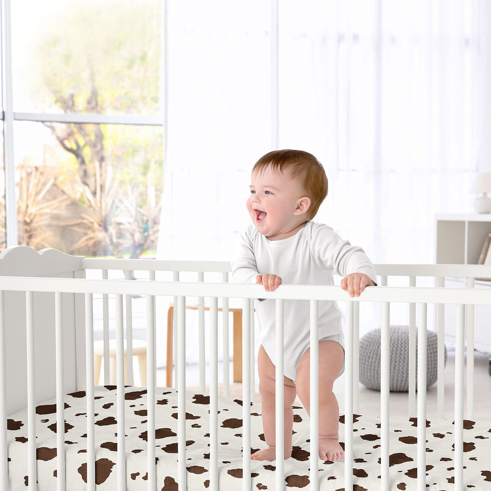 Sweet Jojo Designs cow print crib sheet on crib, easy care and secure fit.