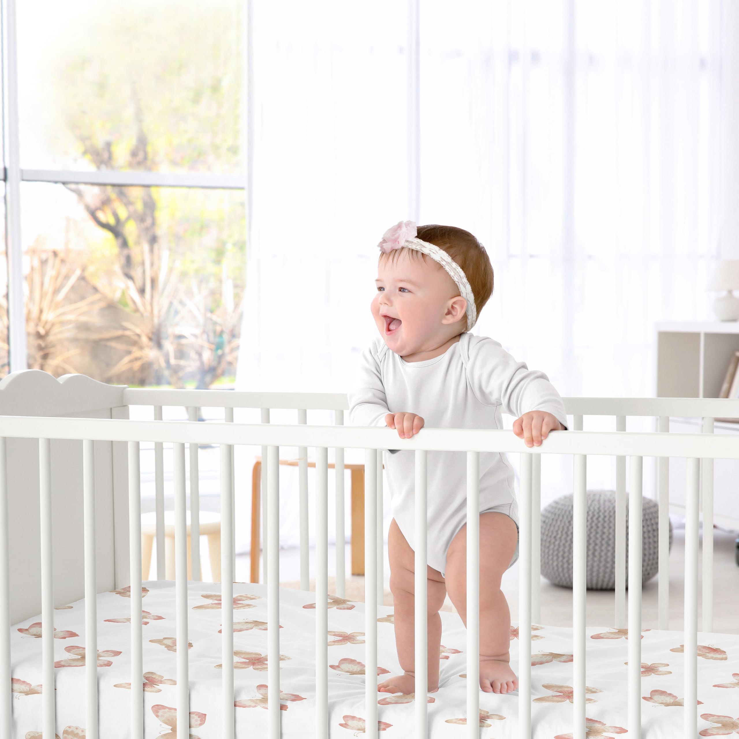 Sweet Jojo Designs crib sheet folded on bed showing snug fit and softness.