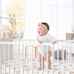 Sweet Jojo Designs crib sheet folded on bed showing snug fit and softness.