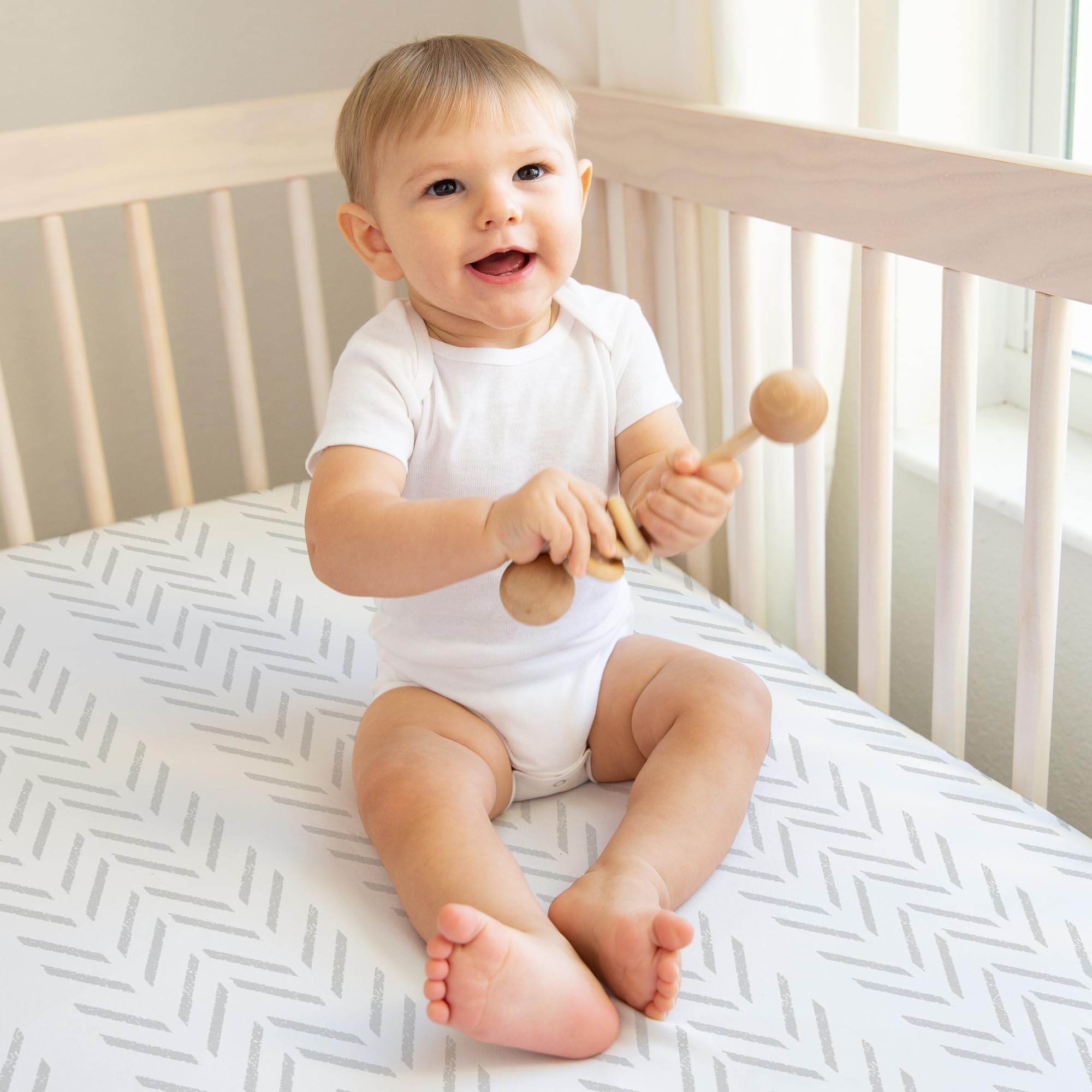 Sweet Jojo Designs grey-and-white tire tracks crib sheet enhances nursery style and fit.