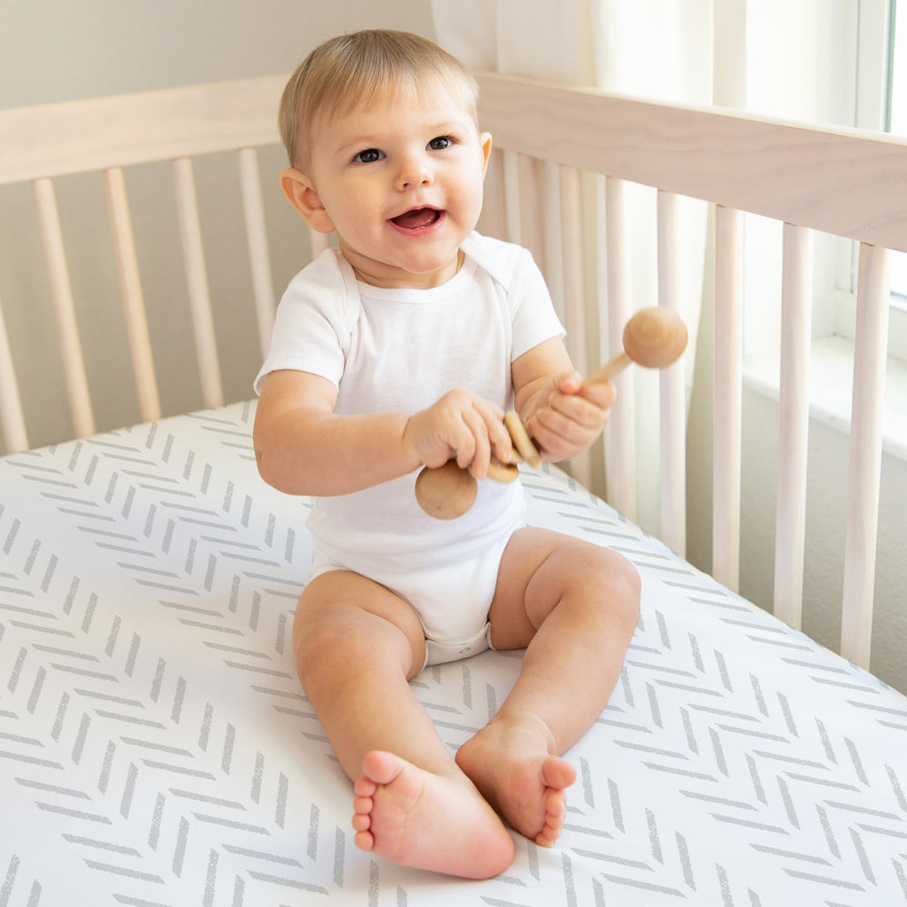 Sweet Jojo Designs grey-and-white tire tracks crib sheet enhances nursery style and fit.