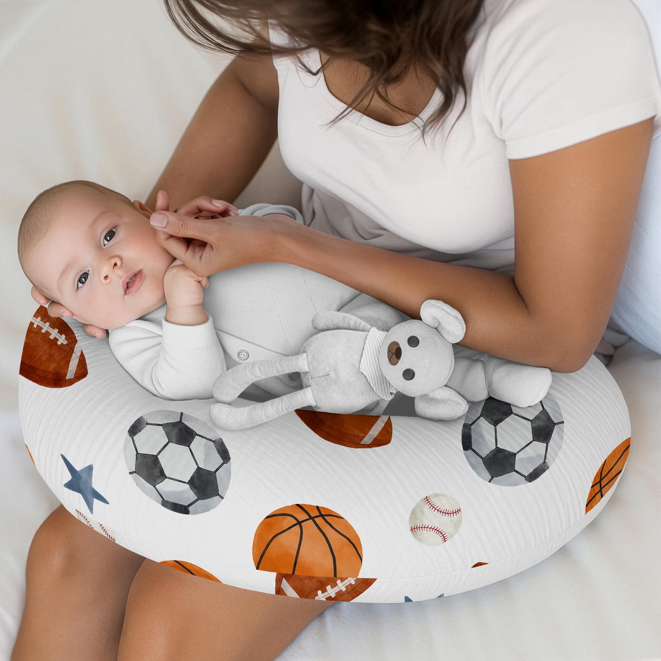 Sports-ball pattern on breathable cotton muslin for gentle baby skin.