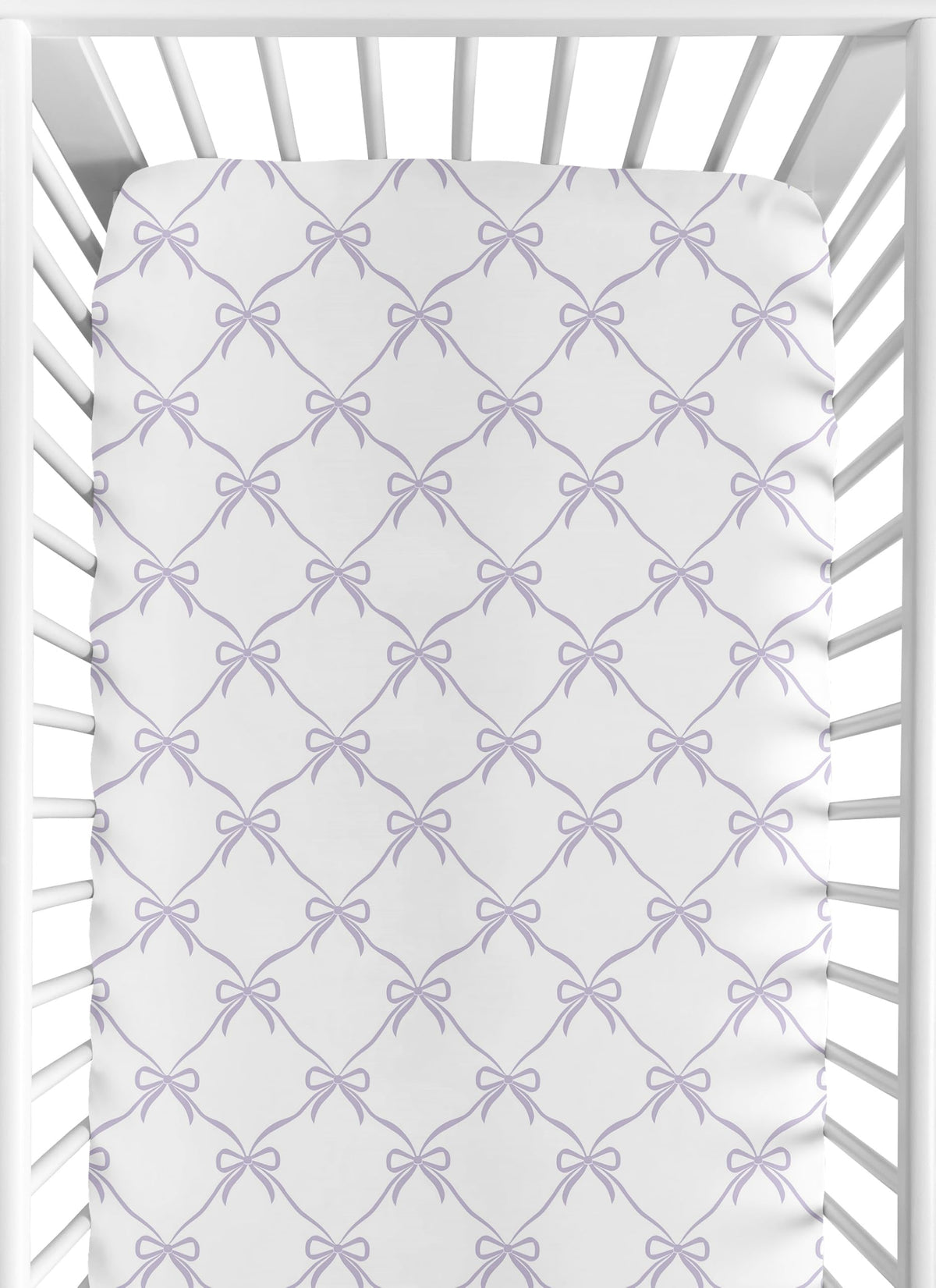 Sweet Jojo Designs purple bows fitted crib sheet showing snug fit for standard cribs.
