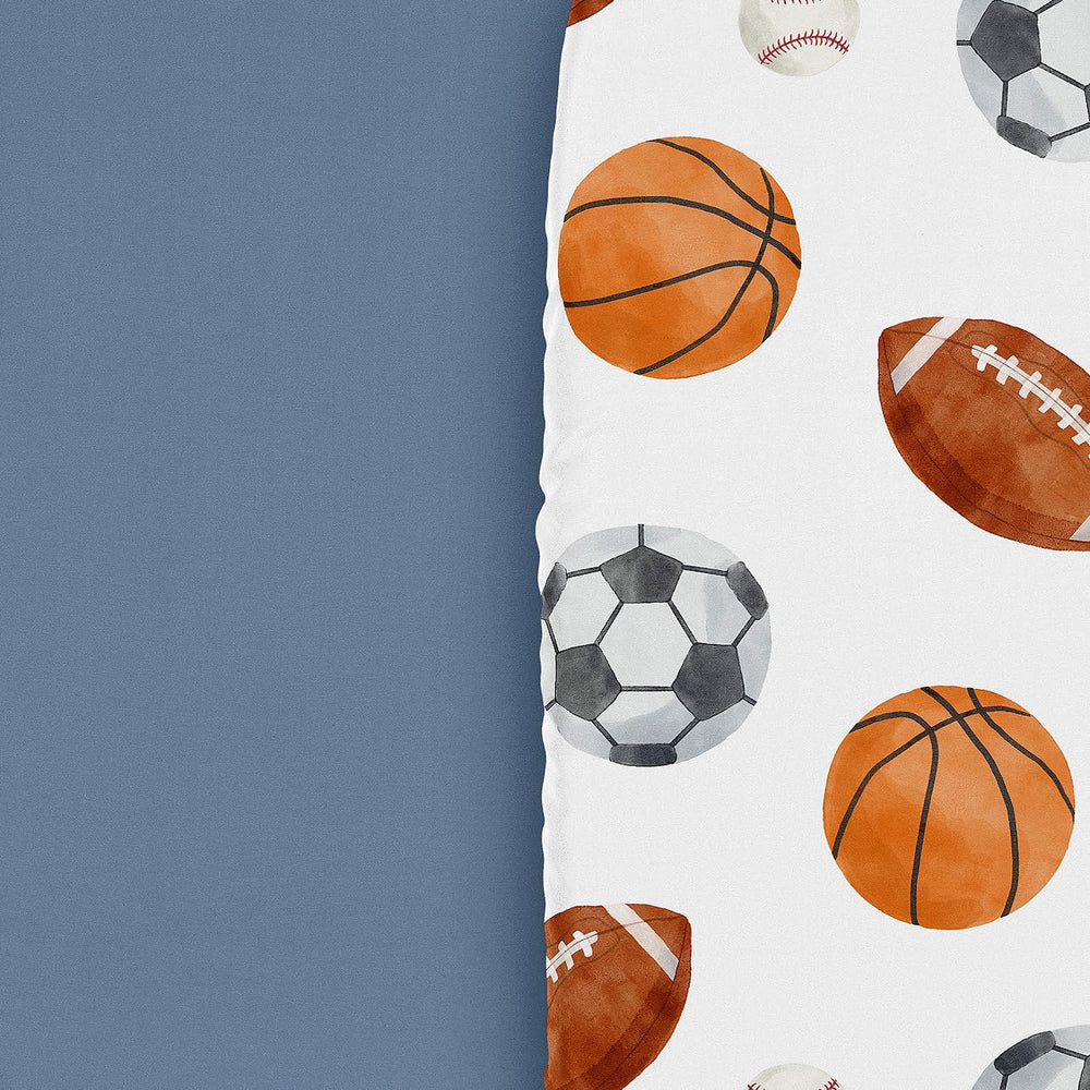Sweet Jojo Designs sport-themed sheets enhance a coordinated, playful nursery decor.