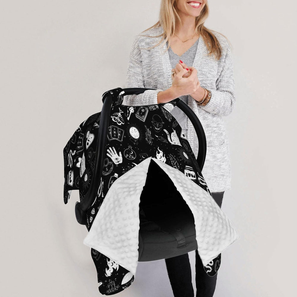 Goth car seat cover doubles as nursing cover for versatile use.