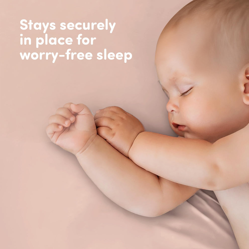 Gender-neutral white and pink crib sheets suit boys, girls, or neutral nurseries.