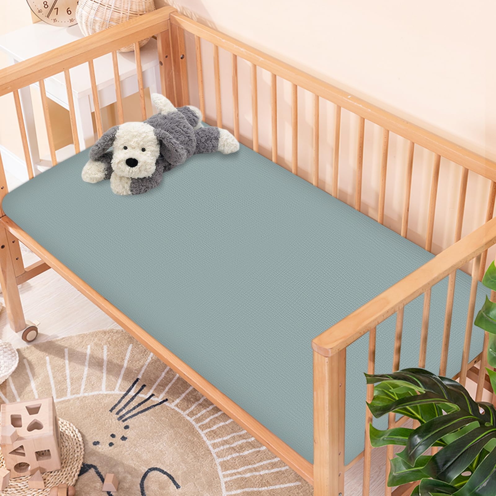 Synrroe muslin crib sheet breathable fabric supports all-season infant comfort.