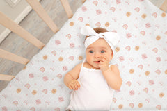TADO MUSLIN 360-elastic secure-fit close view keeps sheet snug on standard cribs.