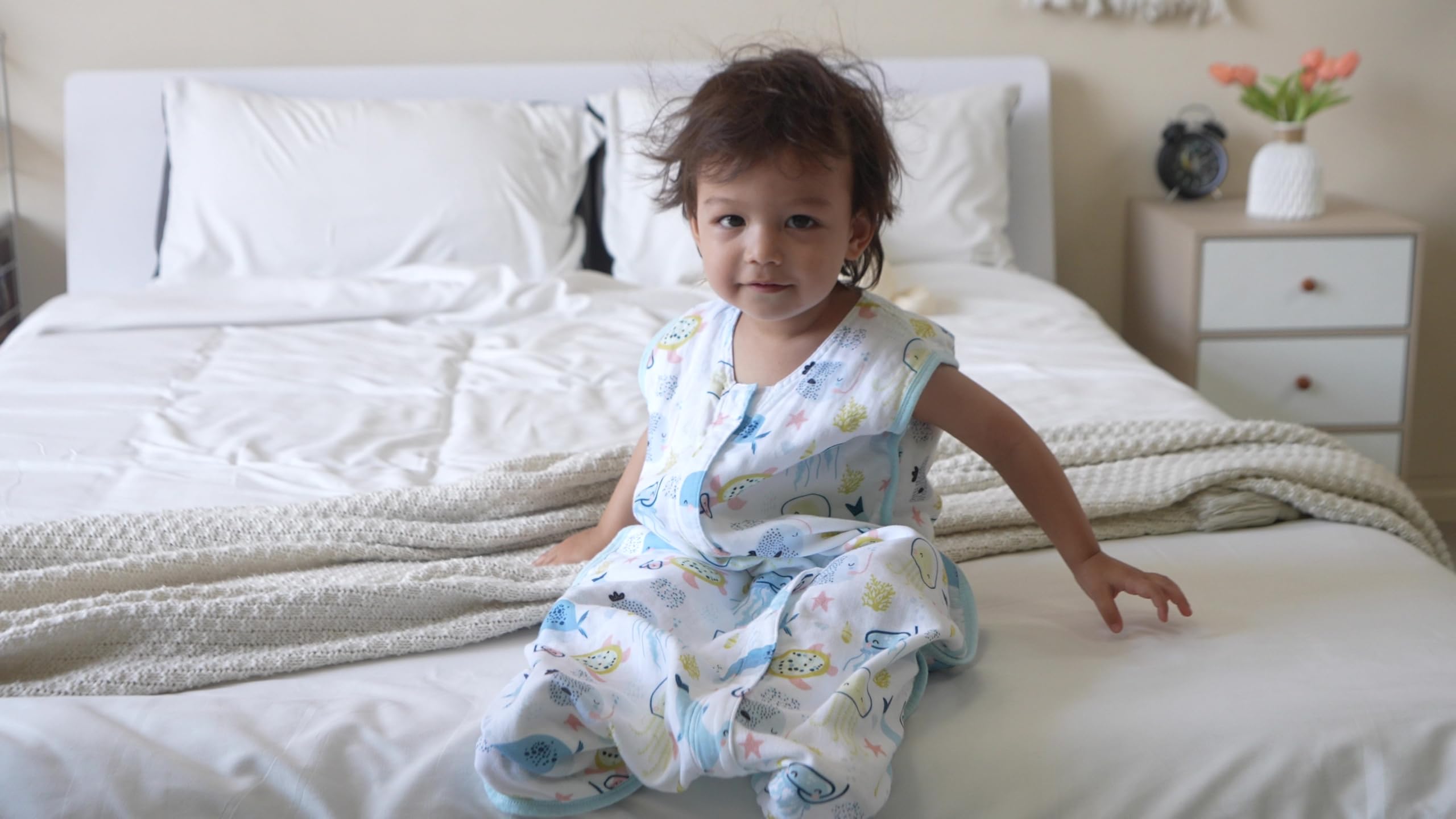 Tado Muslin Toddler Sleep Sack worn by child illustrating sleeveless design for airflow.
