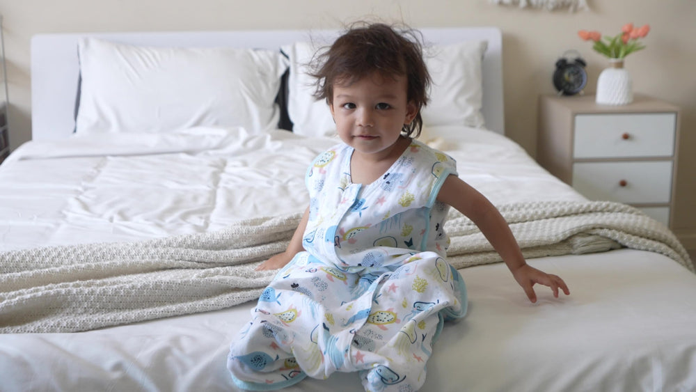 Tado Muslin Toddler Sleep Sack worn by child illustrating sleeveless design for airflow.