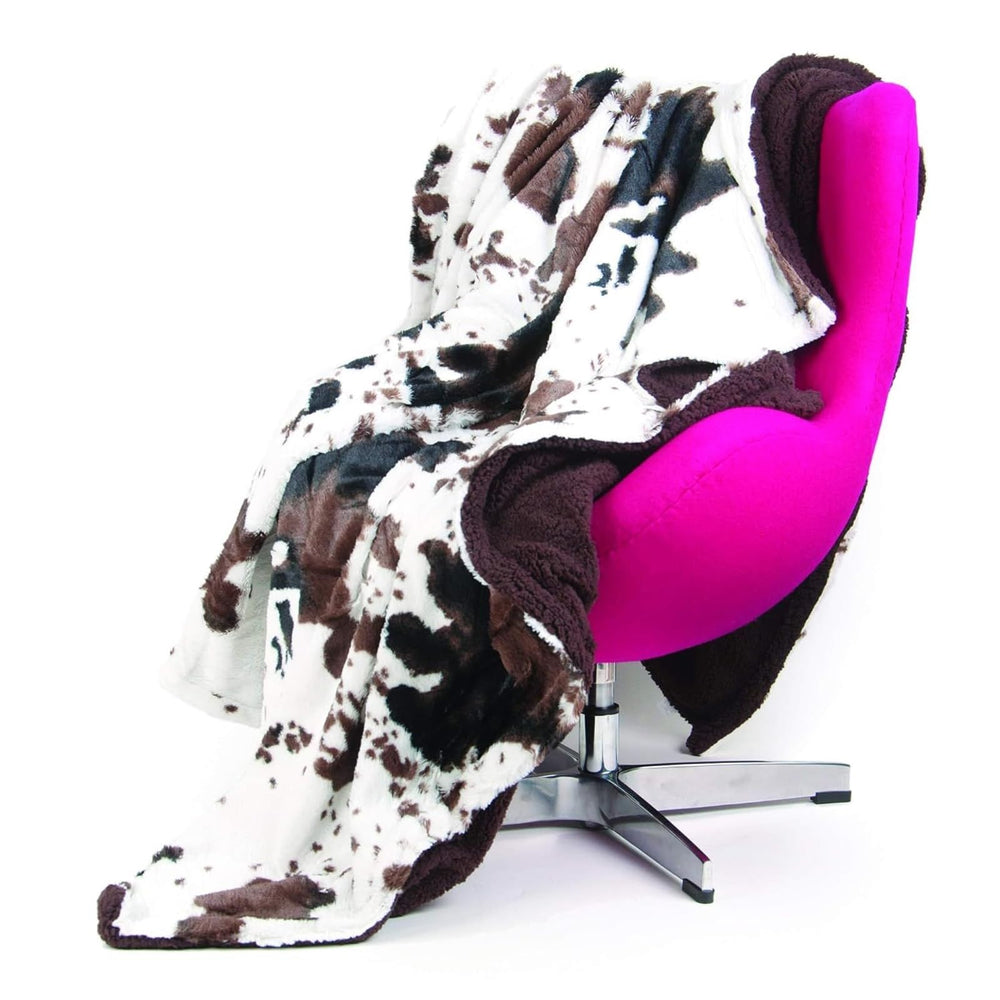 Tadpoles plush sherpa cowhide blanket in crib with double-layer comfort