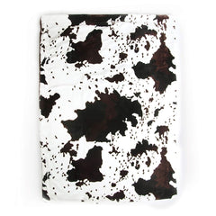 Tadpoles plush sherpa cowhide blanket folded for storage