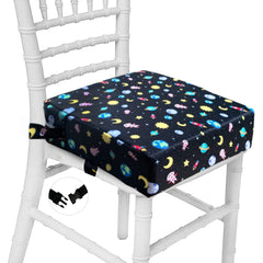 Taeku booster seat on a dining table in Planet Black, ready for family mealtime.