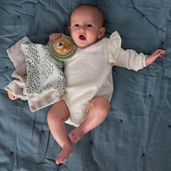 Pacifier Velcro strap keeps a soother within reach for quick soothing.