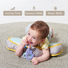 Taf Toys baby lying on tummy time cushion with attachable toys in reach.