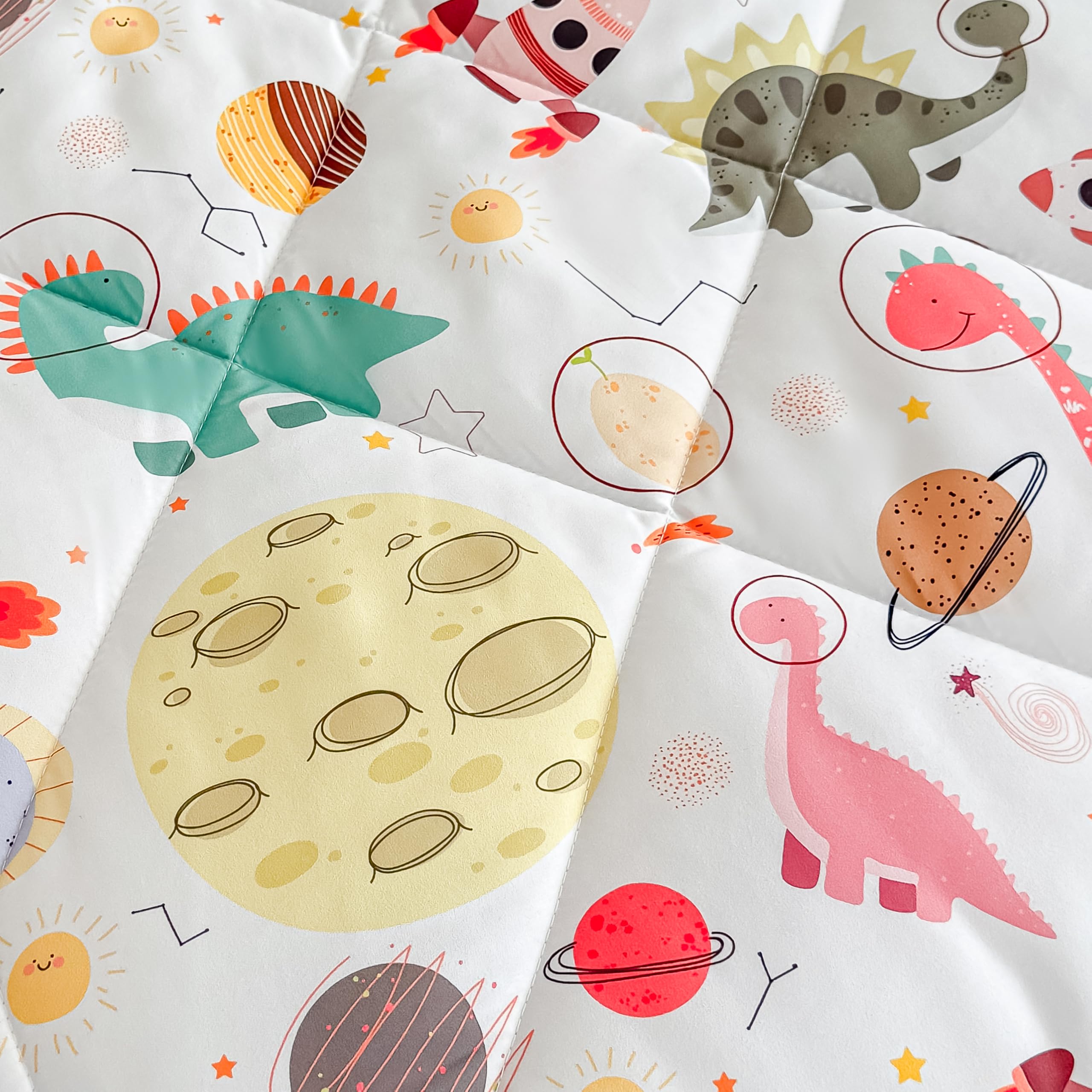 Tailor Shop dinosaur toddler bedding in bedroom with bright dinosaur pattern