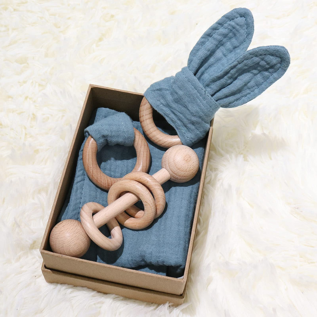 Tanofar baby lovey and wood rattle for soothing sensory play and teething comfort.